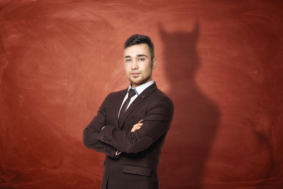 Business man with devil shadow