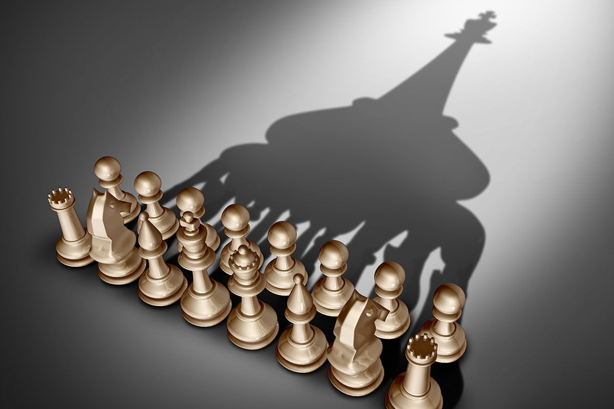 Chess set with pieces casting a bigger picture shadow