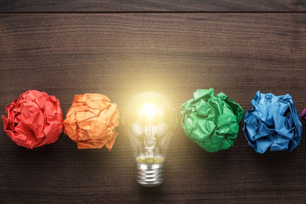 Lightbulb and balls of coloured paper