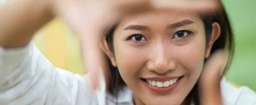 Woman framing face with hands