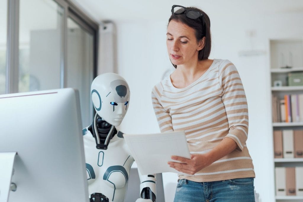 Employee working with AI robot in workplace